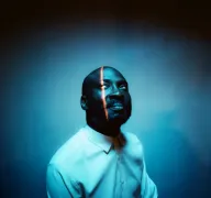 Eine Person blickt im blauen Licht nach oben.