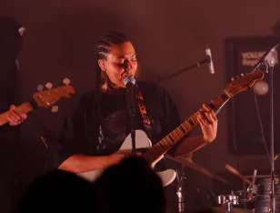 Nenda singt und spielt dazu Gitarre